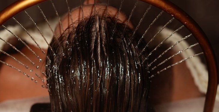 Gentle salon hair wash and scalp care beneath a water halo